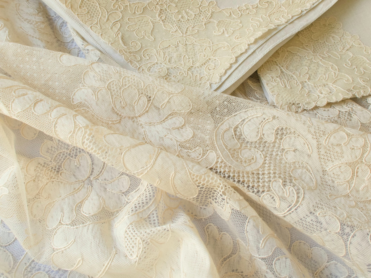 Layered view of Alençon lace tablecloth and napkins showing texture and transparency