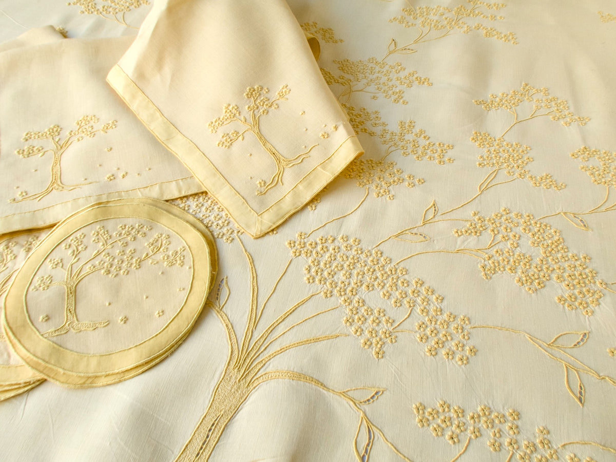 Close-up of Jacaranda Tree embroidery on yellow linen Marghab tablecloth