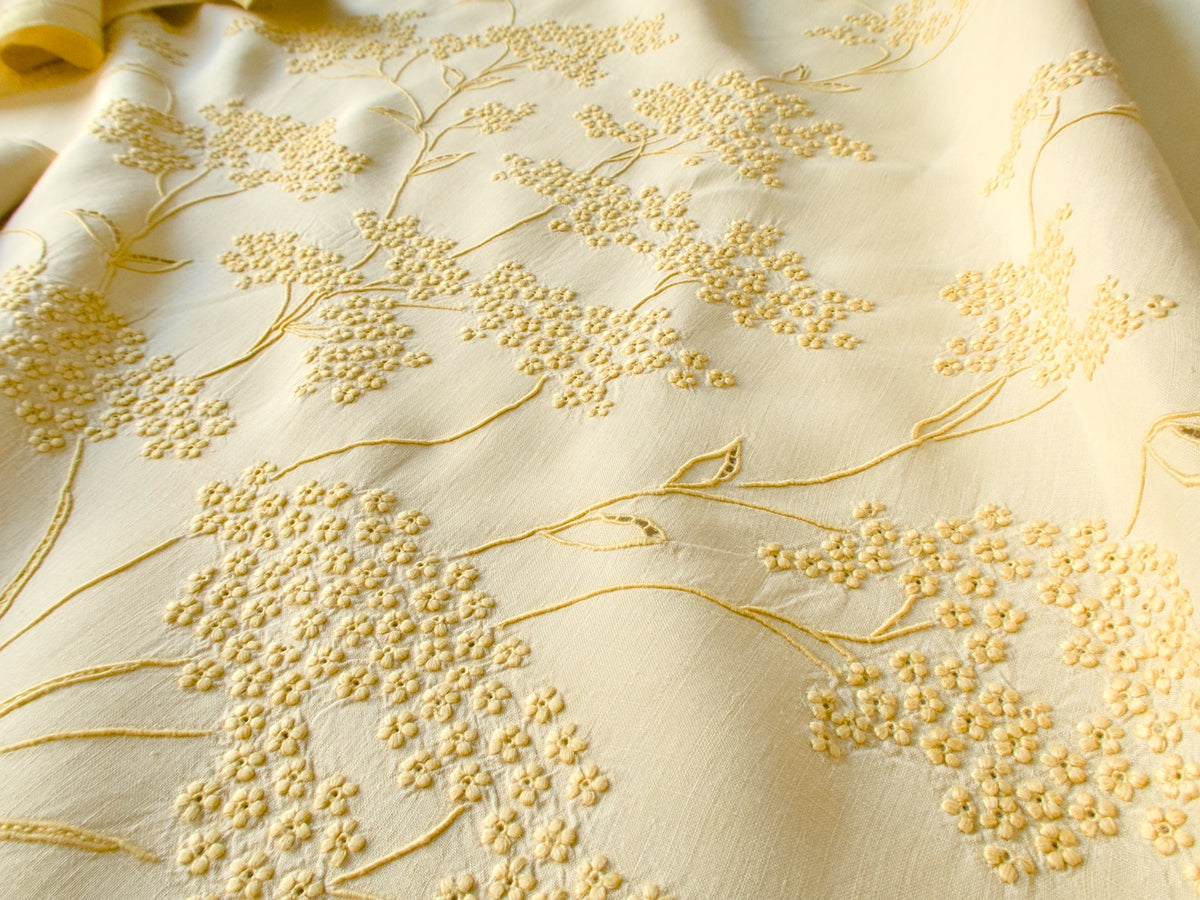 Close-up of Jacaranda Tree embroidery on yellow linen Marghab tablecloth