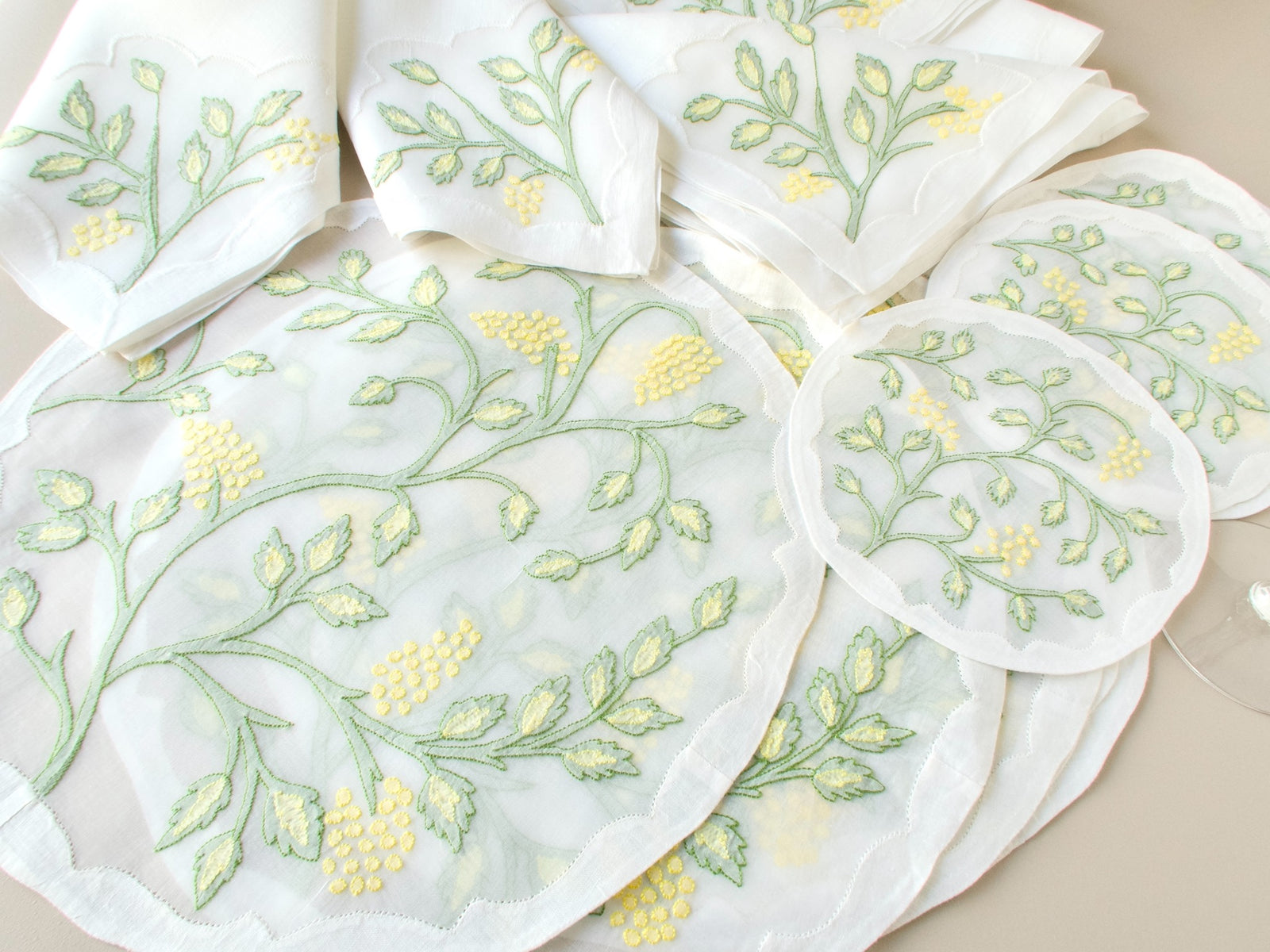Full 18-piece vintage Madeira Jacobean shadow work placemat set showing six placemats, six napkins and six coasters laid out on beige background