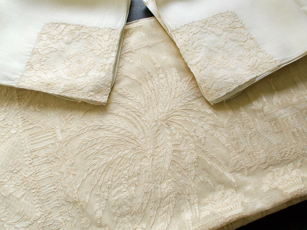 Matching napkins with church and tower motifs, vintage French lace