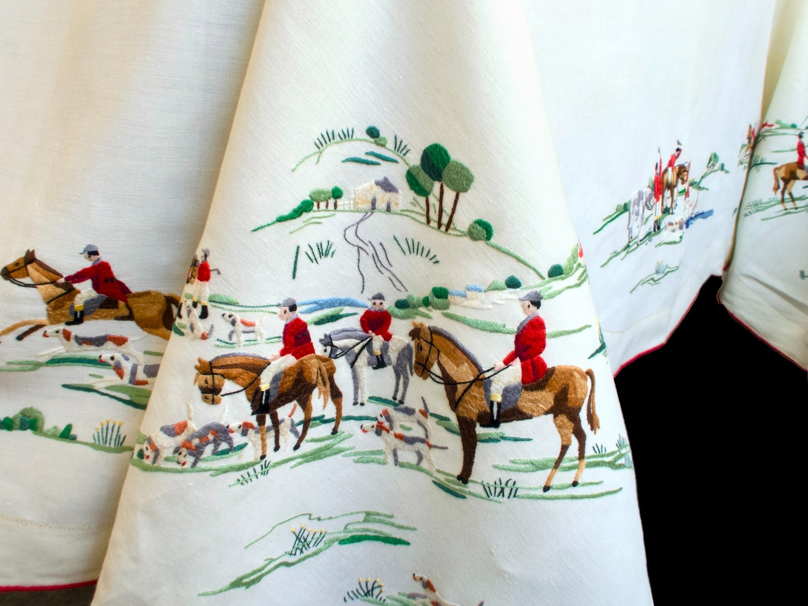 Vintage Madeira tablecloth corner hand embroidered with red-coated riders, hounds and a hilltop farmhouse in rolling countryside