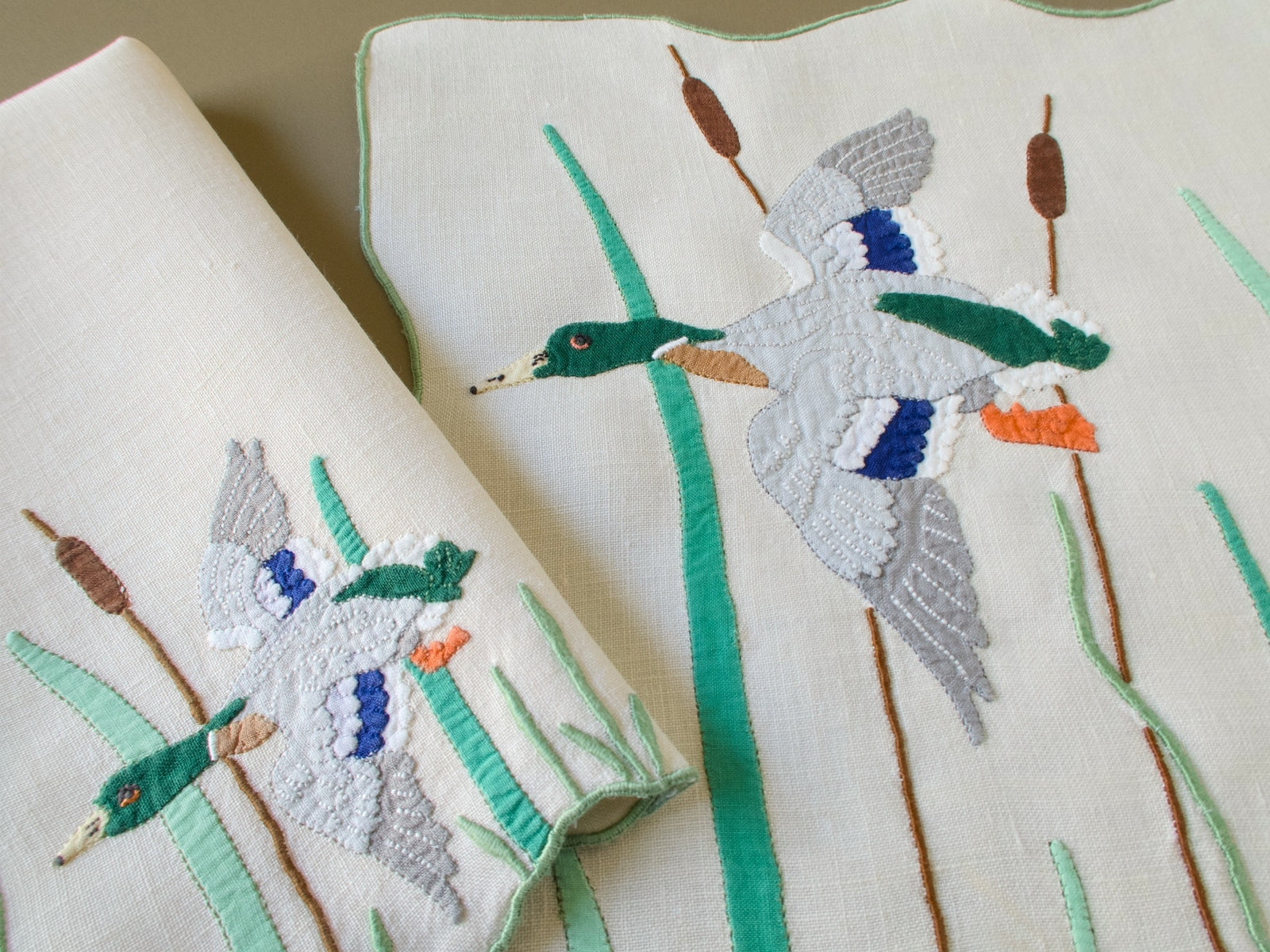 Vintage Madeira placemat and folded napkin with flying mallards, cattails and green edging