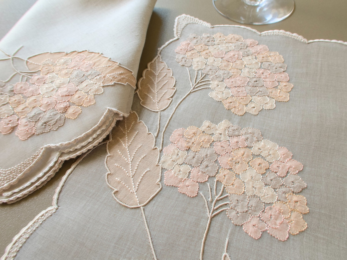 Vintage Marghab “Hydrangea” placemat and napkin set, hand embroidered in Madeira on fine organdy and linen, featuring intricate hydrangea blossoms in soft shades of cream and beige.