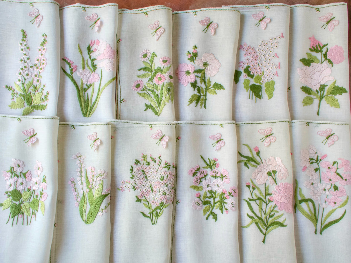 Complete 25-piece Rapisardi pink floral service, every placemat and napkin with a unique flower design.