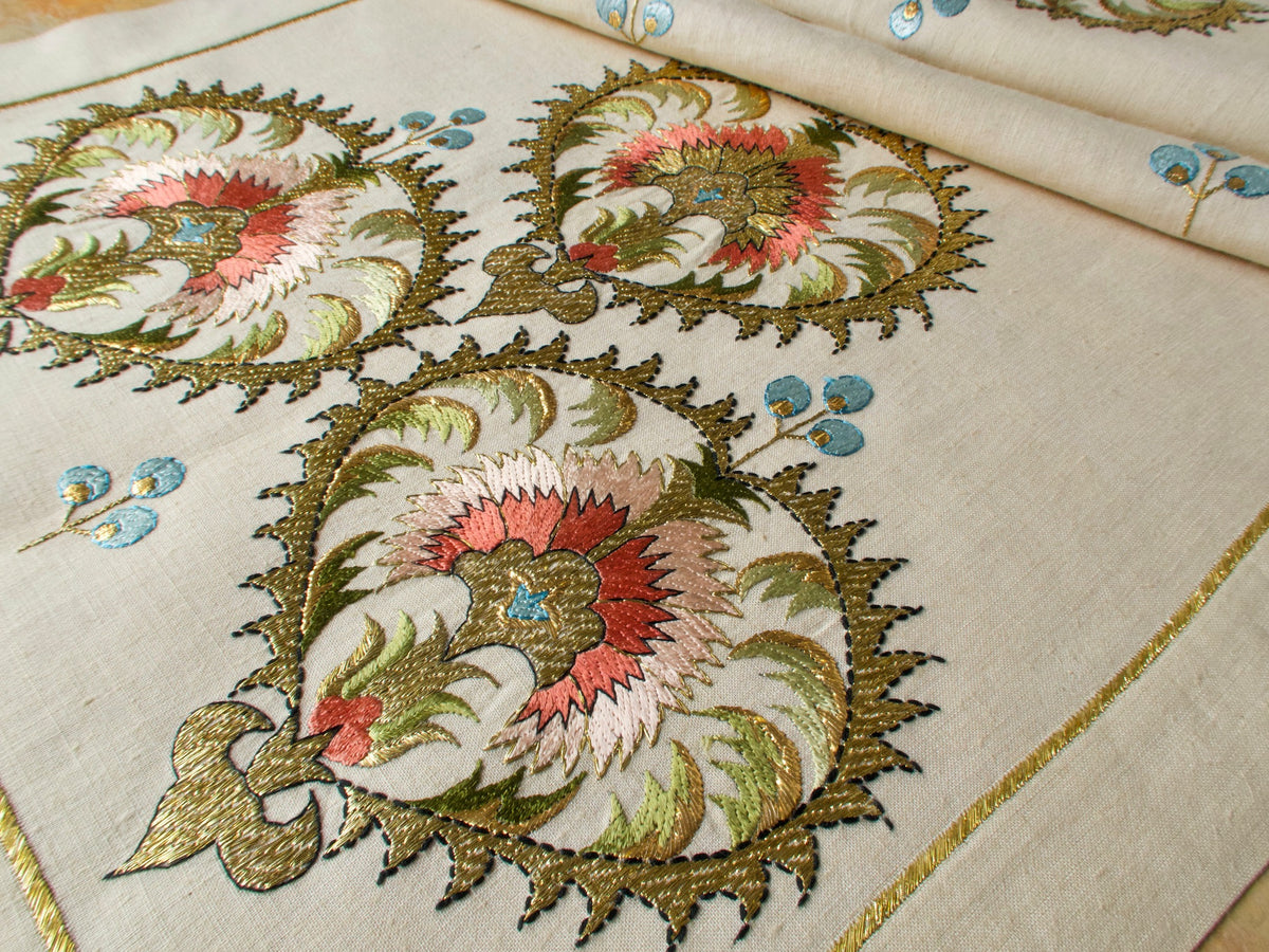 Close-up of intricately Ottoman-inspired embroidered vintage linen table runner with floral patterns, Greek embroidery 