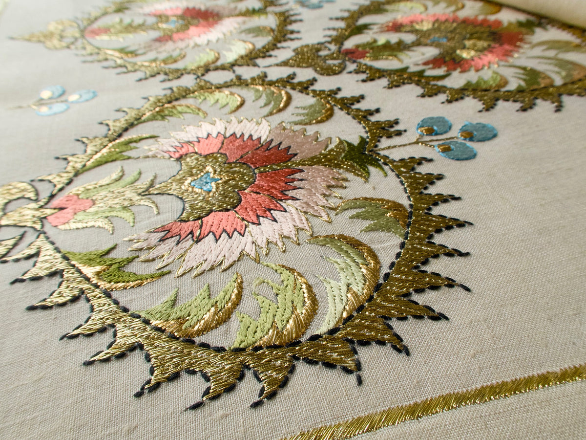 Close-up of intricately Ottoman-inspired embroidered linen table runner with floral patterns, vintage Greek embroidery 
