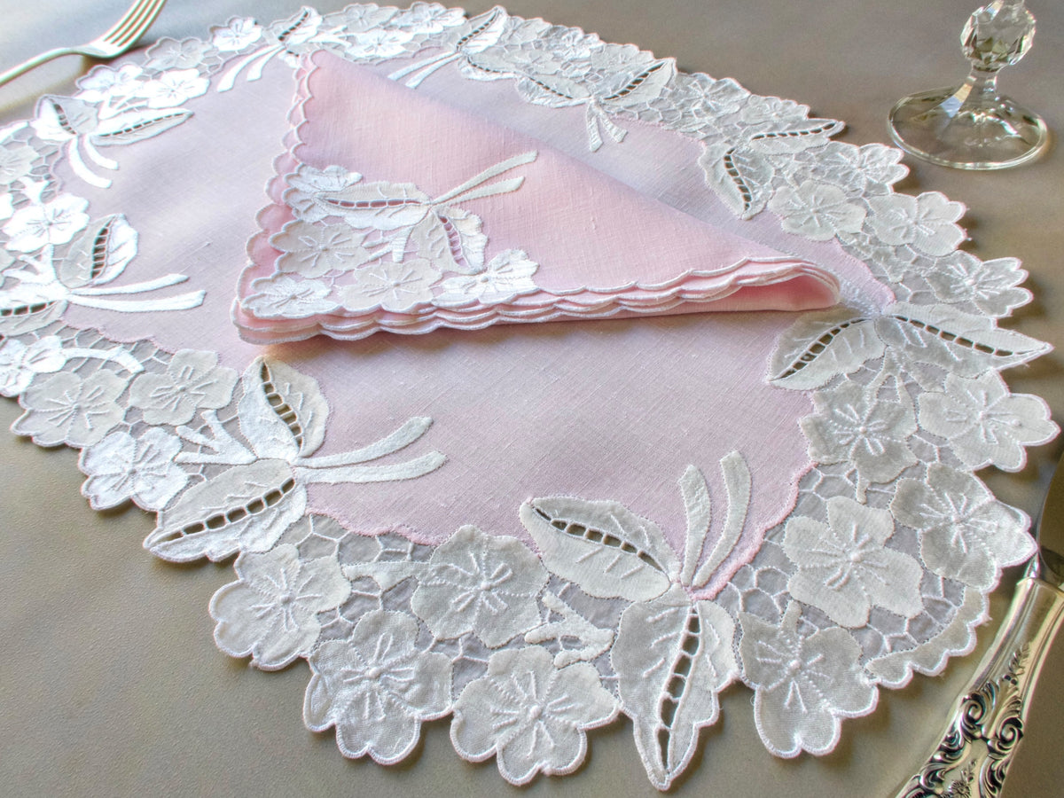 Pink linen placemats with white Madeira embroidery, organdy honeycomb border and matching scalloped napkins.