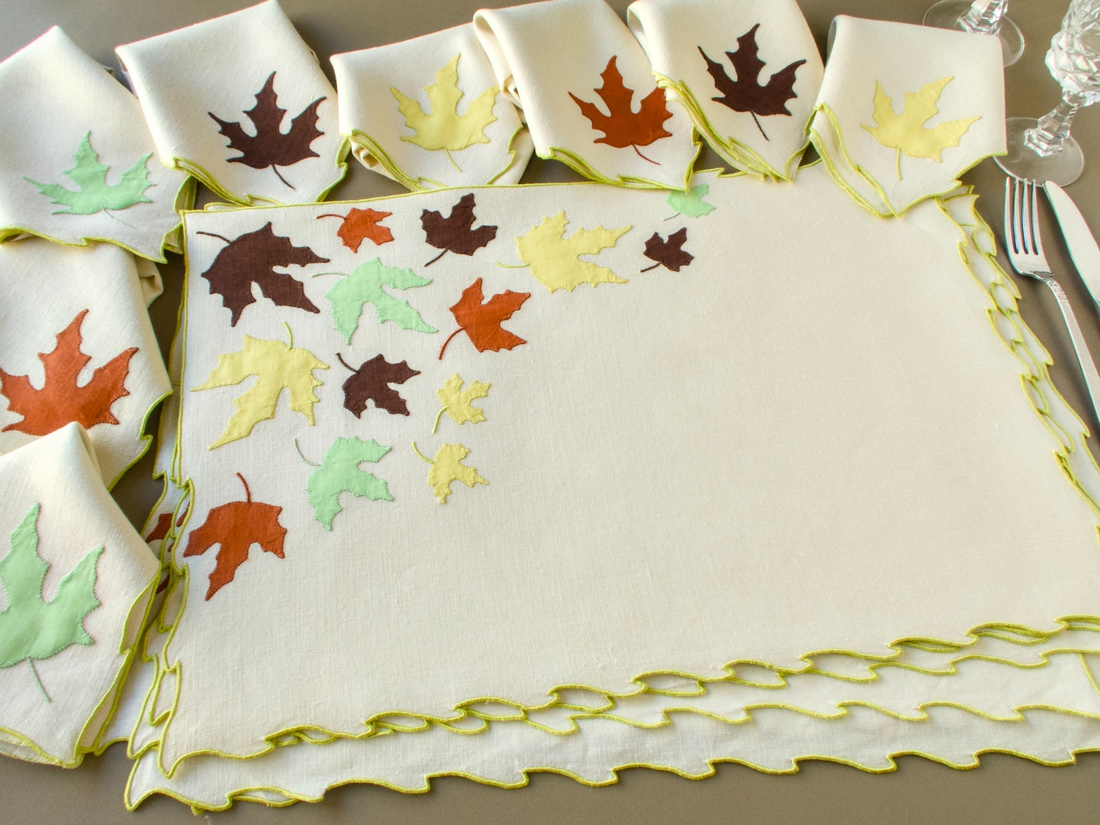 Full vintage Marghab "Autumn Leaves" setting with a placemat, napkins each carrying one appliqué leaf, crystal glasses and silver flatware