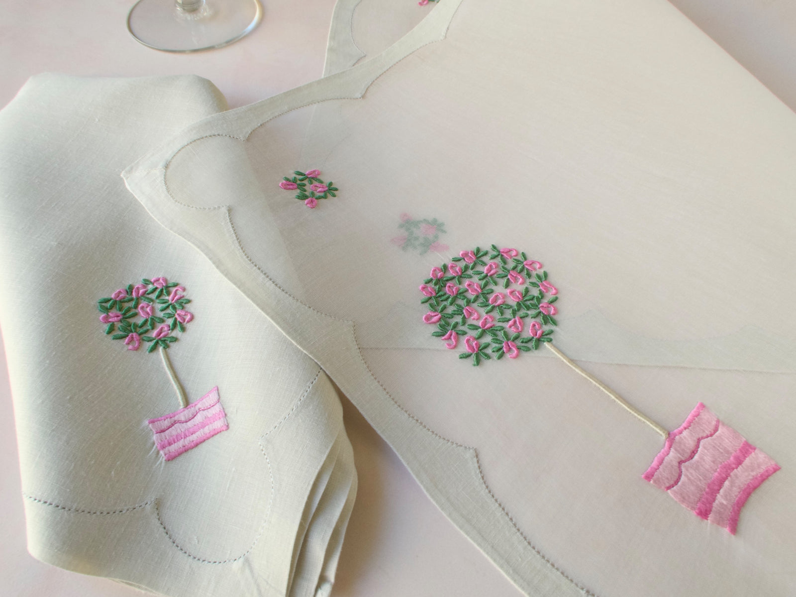 Detail of raised pink and green rose tree embroidery on vintage Madeira organdy placemat.