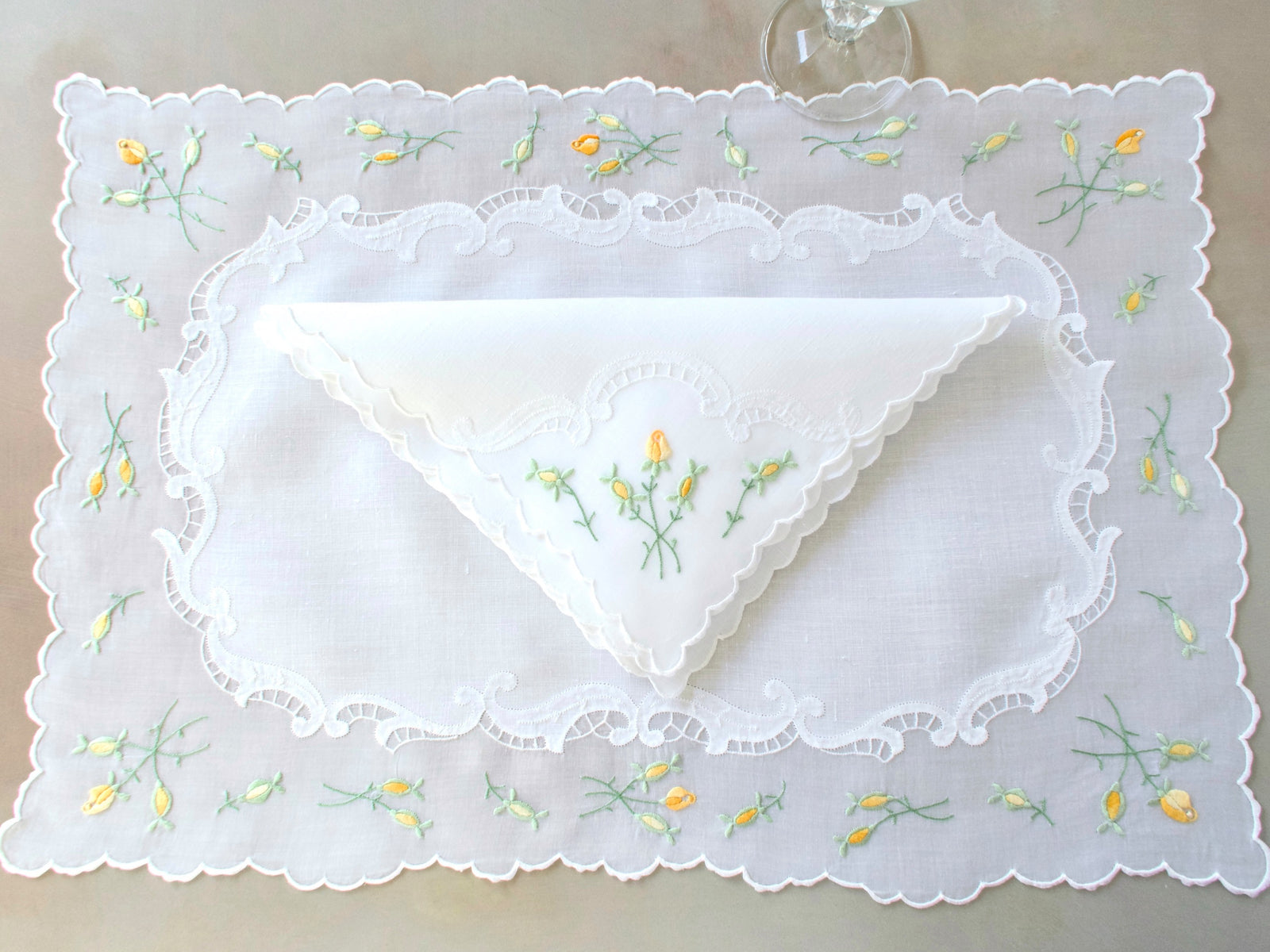  Madeira embroidered placemat and folded napkin showing yellow rosebuds and scalloped organdy edging on white linen