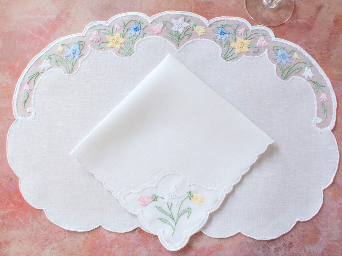 Vintage Madeira oval placemat set for 4 with folded napkin showing spring flower embroidery in organdy windows.