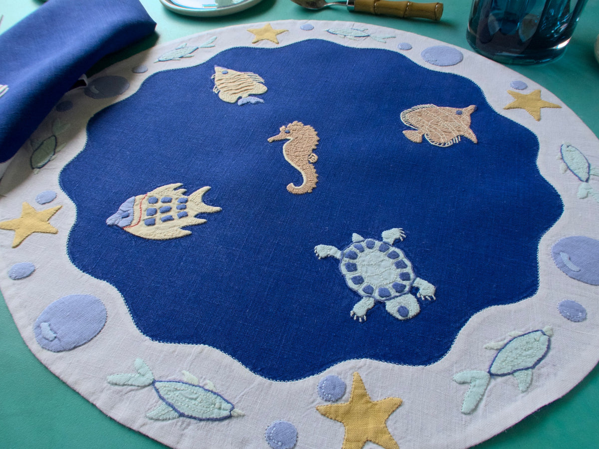 sea creatures embroidered on a round linen placemat