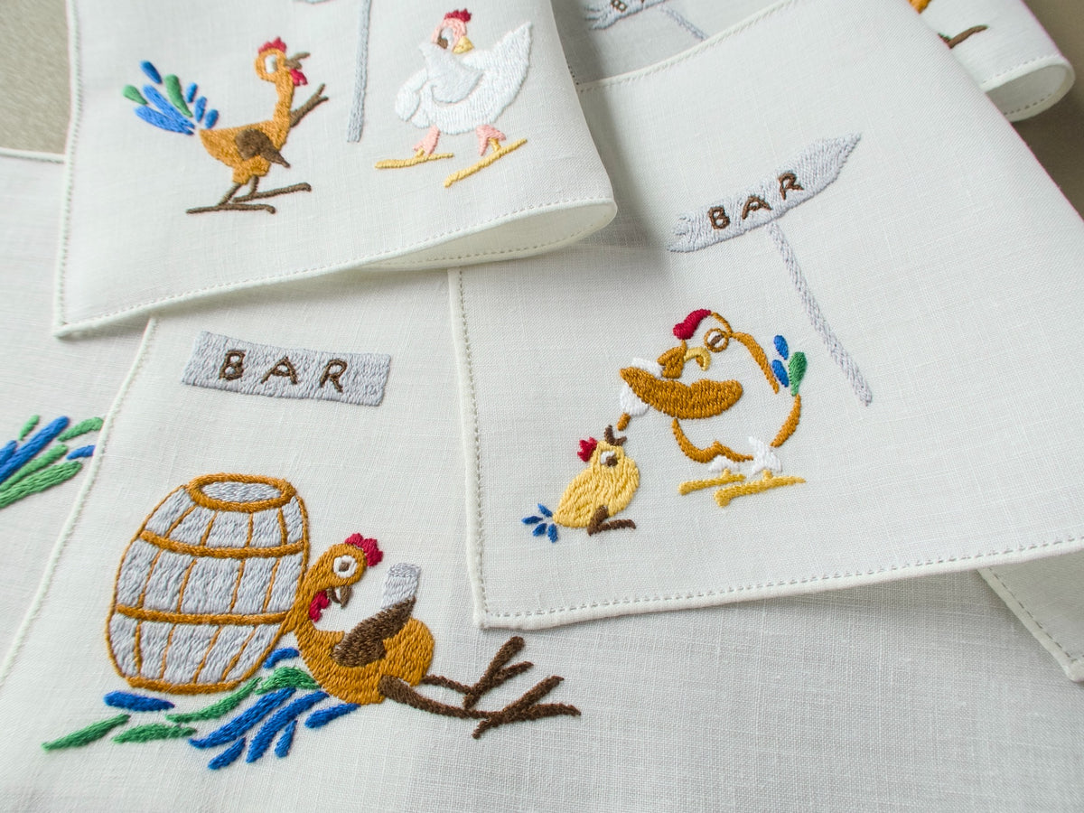 Vintage Rapisardi linen cocktail napkins with a rooster at a barrel and a bleary-eyed hen feeding a chick