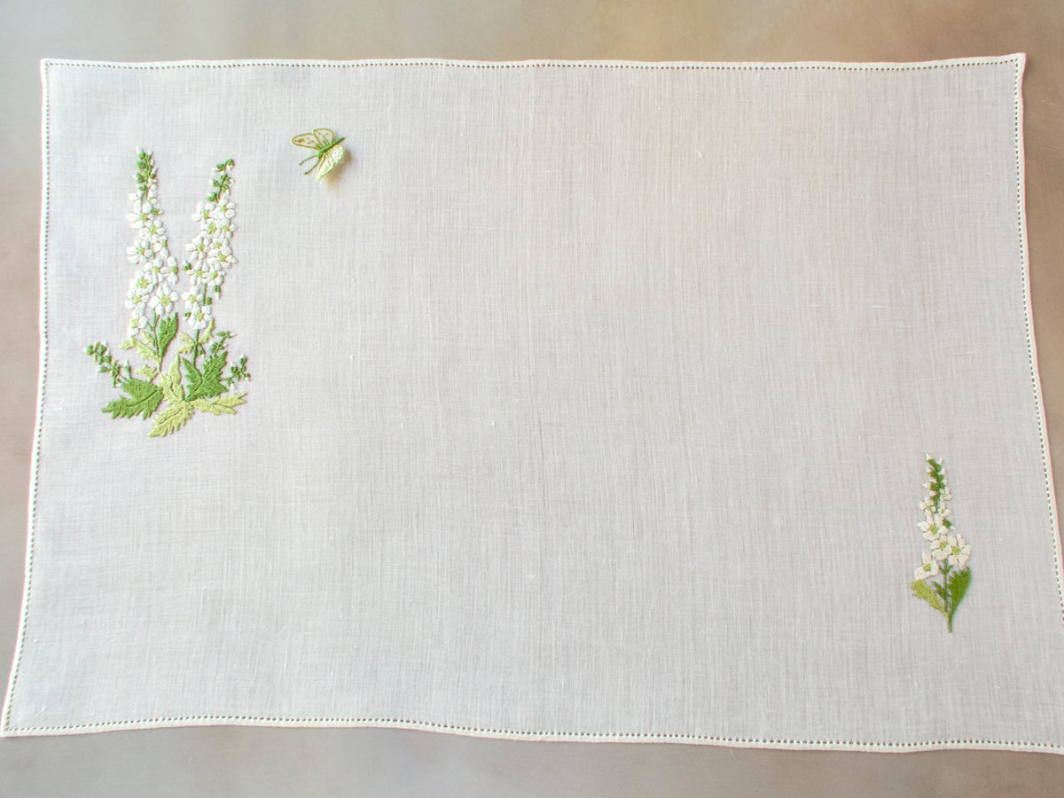 Vintage Rapisardi linen tray cloth hand embroidered with white delphinium and delicate trembler butterfly, shown flat at full length, 15 x 22 inches