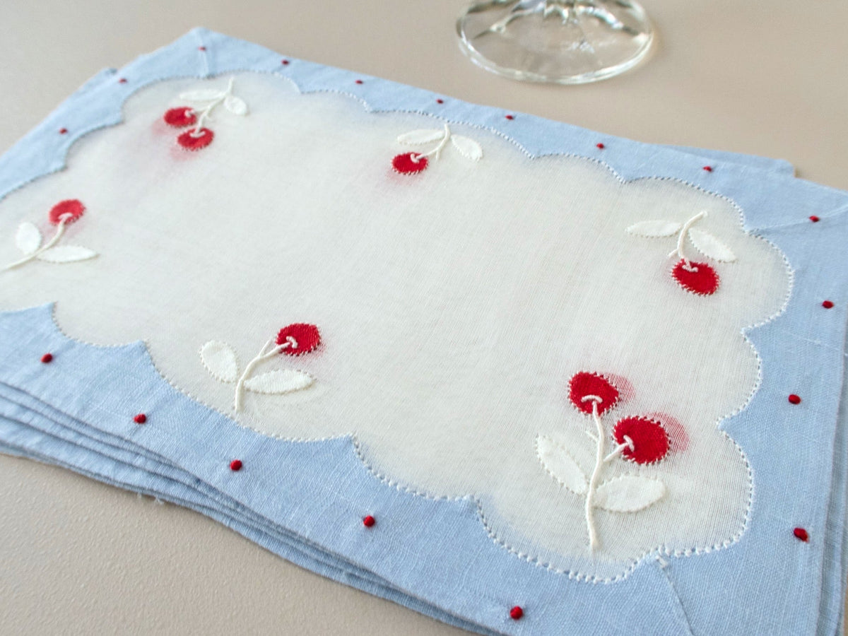  Stack of vintage Madeira cocktail napkins with cherry appliqué, stitched leaves and a scalloped organdy center