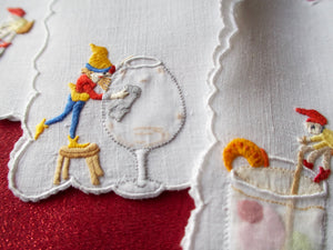 Elves help at the bar, embroidered vintage cocktail napkins.