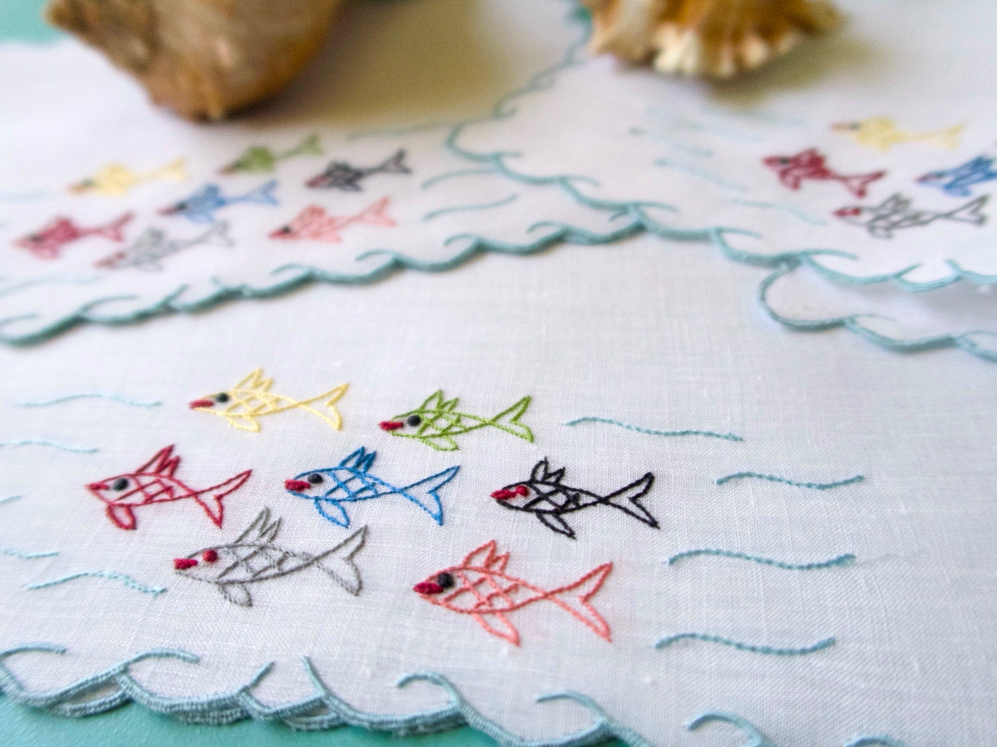 colorful school of fish embroidered on a linen cocktail napkin
