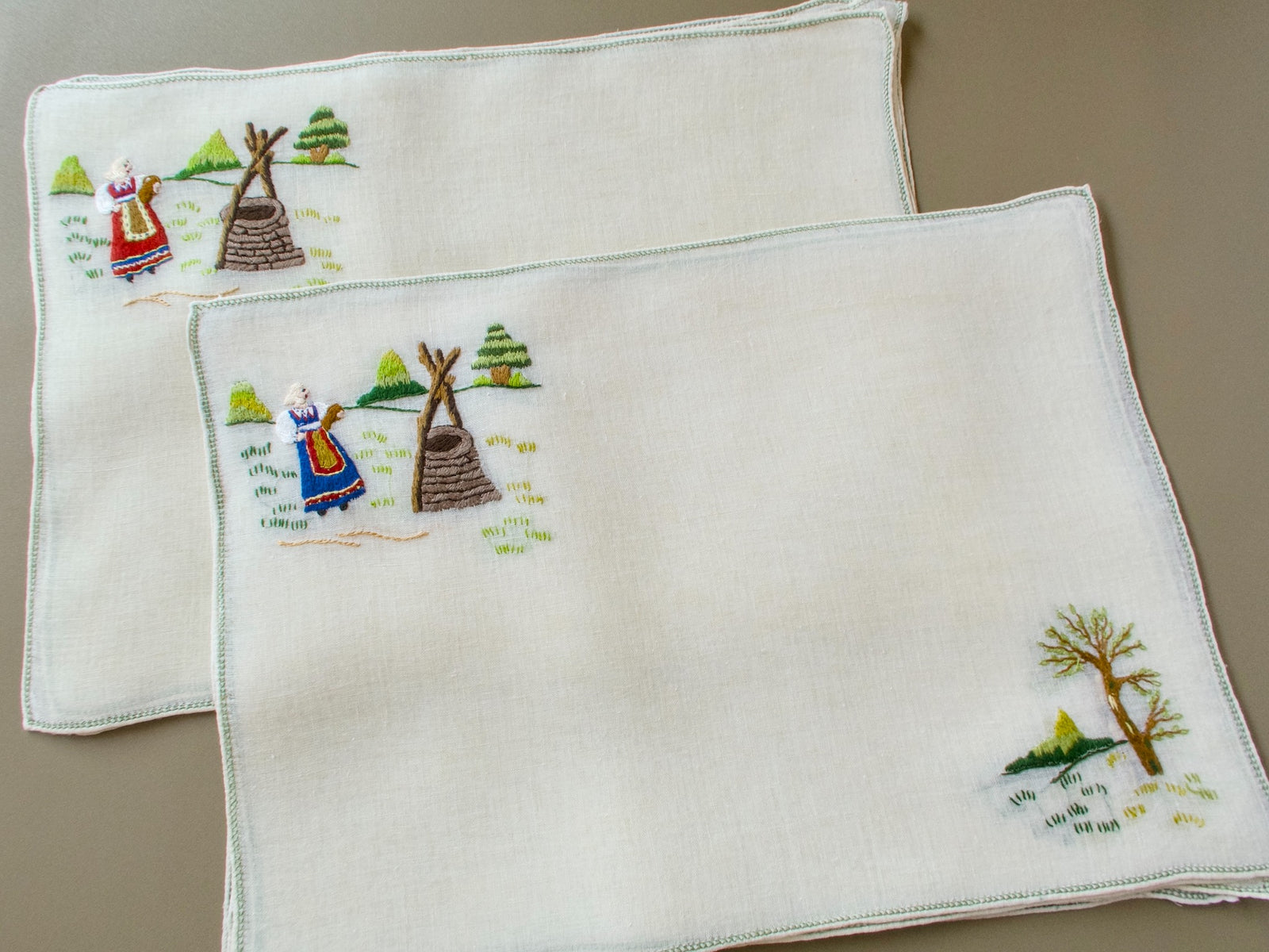 Hand embroidered Rapisardi placemat with regional costume figure and dimensional punto stuoia embroidery