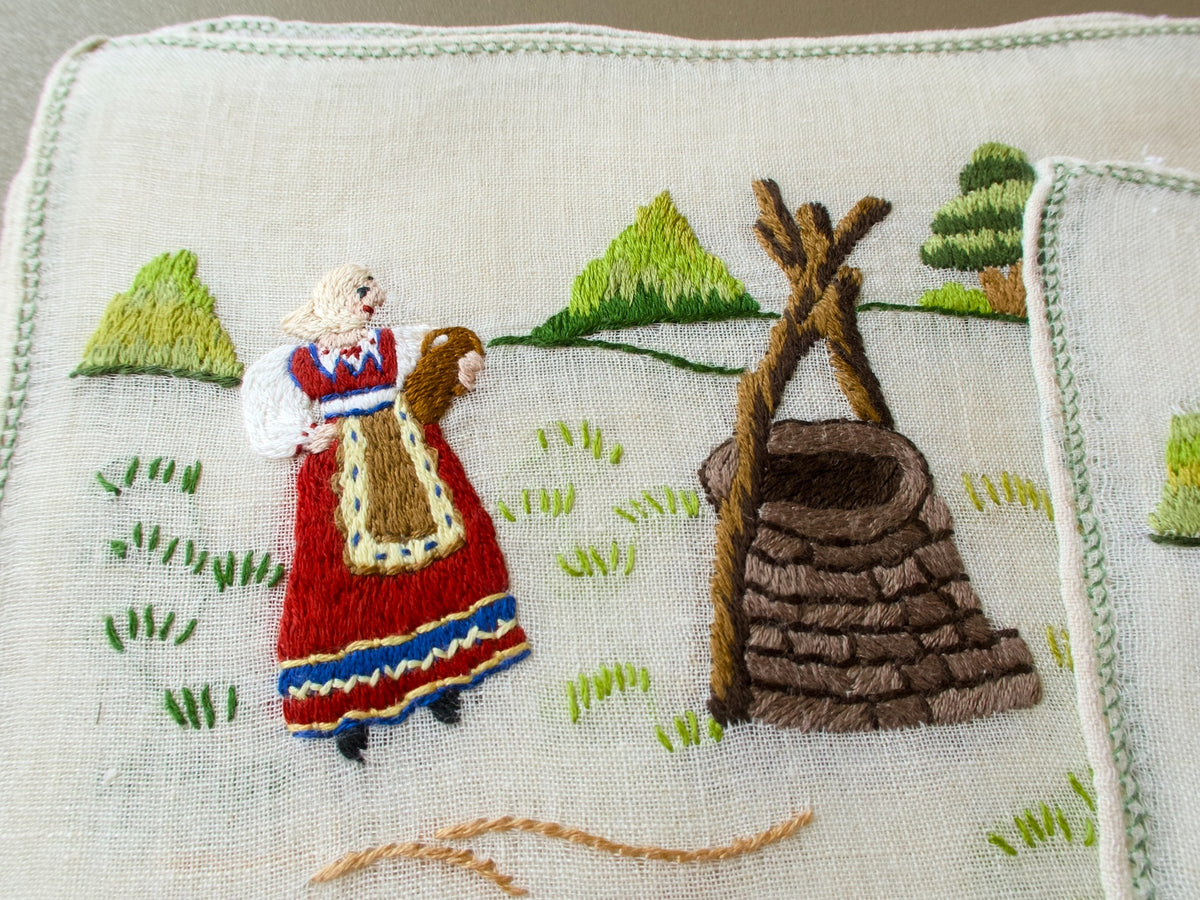 Vintage Baroness Rapisardi placemats with woman in regional costume beside a stone well
