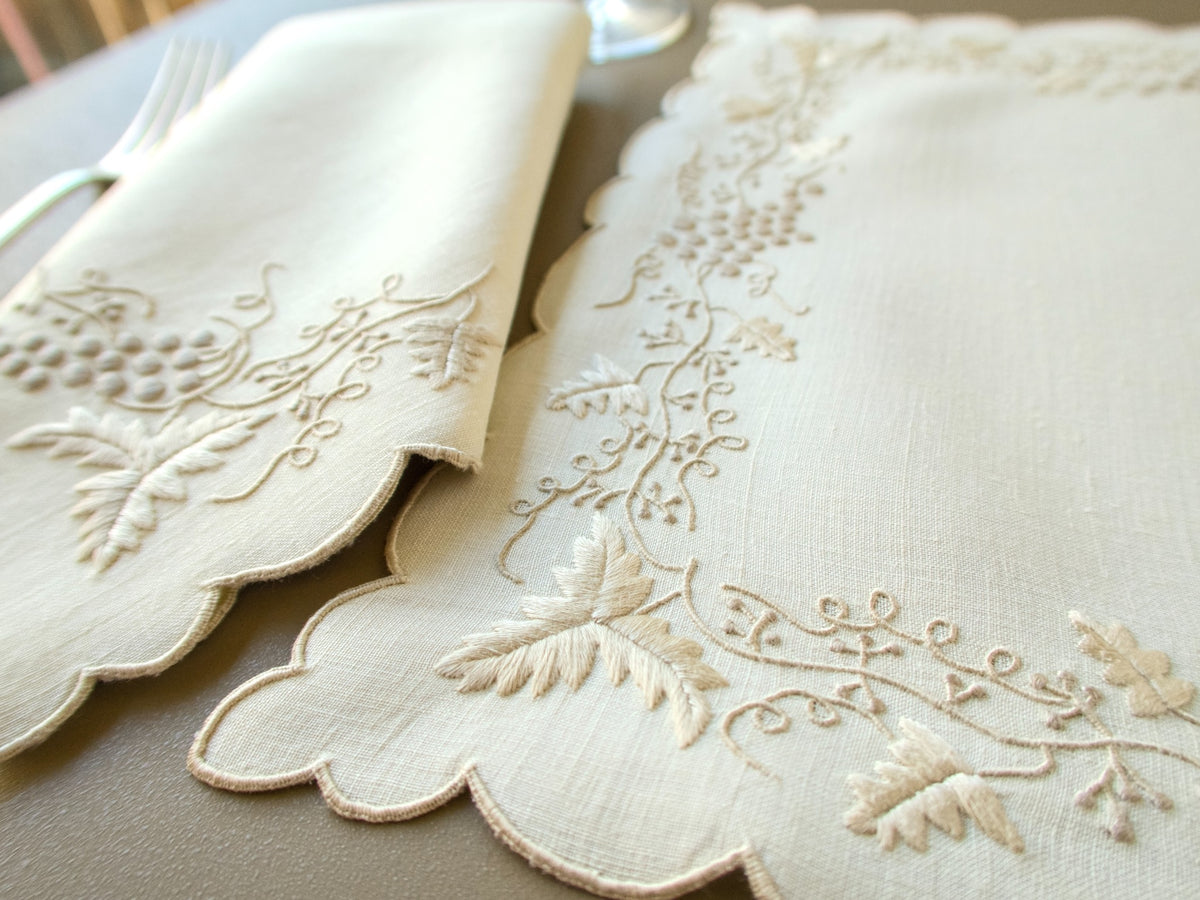 Close-up of dimensional grape and leaf embroidery on vintage Madeira linen placemat