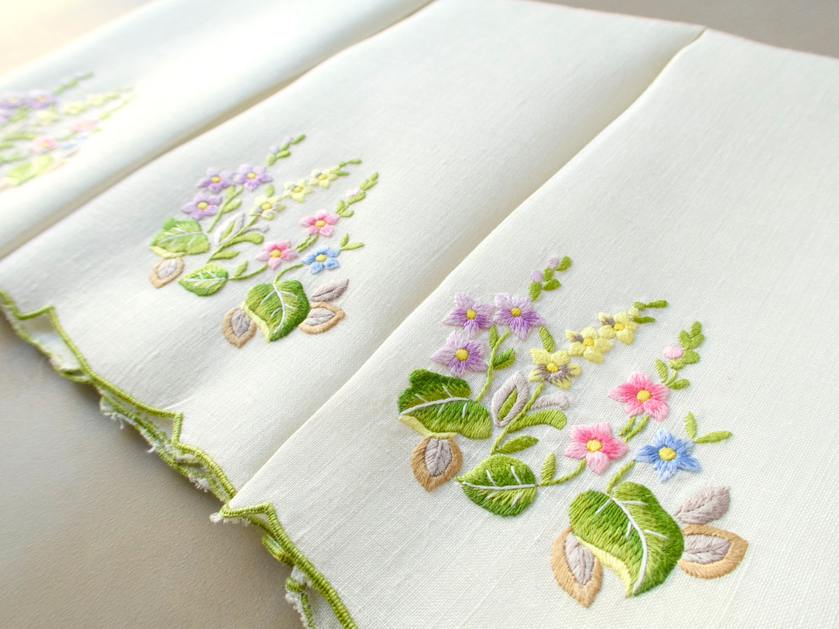 Vintage Belgian linen guest towels hand embroidered in Madeira with colorful floral bouquet and scalloped edge.