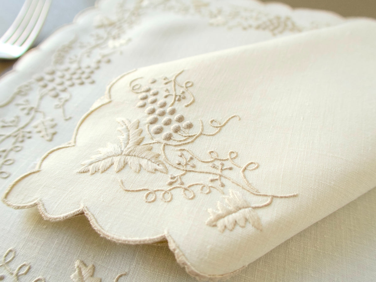 Close-up of dimensional grape and leaf embroidery on vintage Madeira linen placemat
