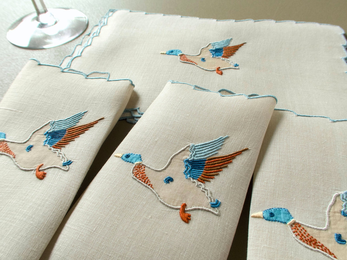Set of vintage Marghab Wild Duck linen cocktail napkins with hand embroidered ducks and blue scalloped edges