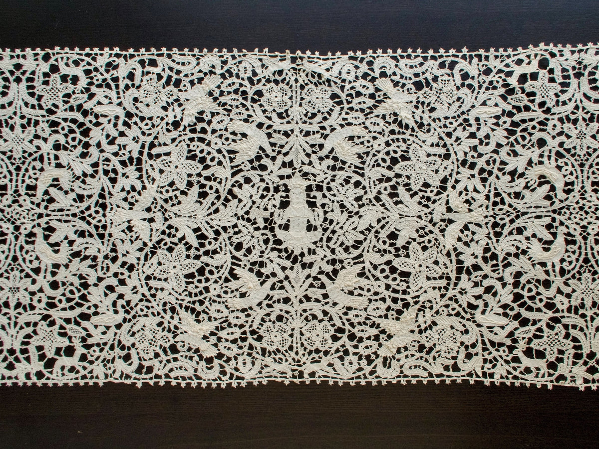 Vintage Italian bobbin lace runner featuring animals, birds and figures.