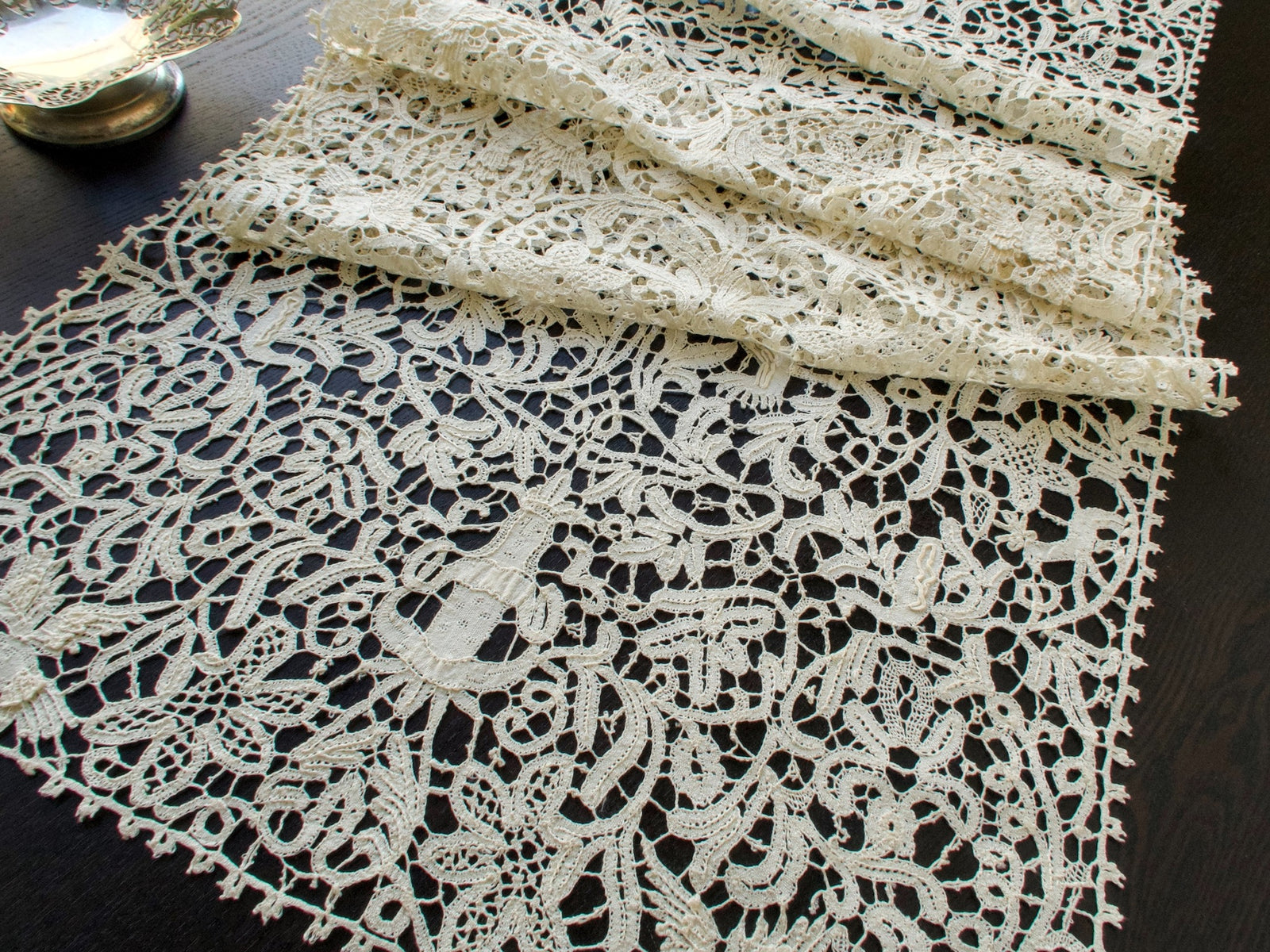 Vintage Italian bobbin lace runner featuring animals, birds and figures.