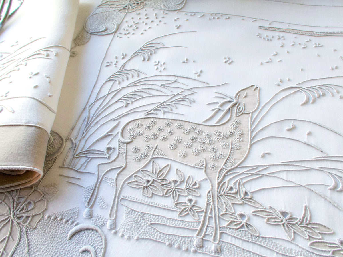 Detail of vintage Marghab “Deer” placemat showing embroidered grasses and landscape in gray organdy.