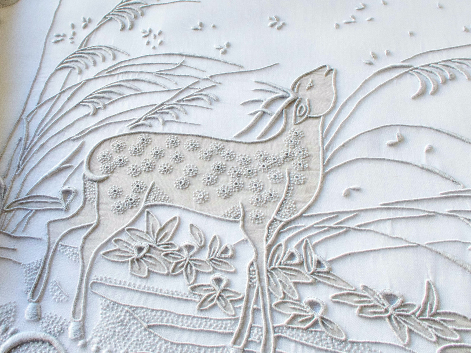 Vintage Marghab “Deer” organdy placemat showing full embroidered landscape scene with deer, grasses, and crescent moon in light gray.