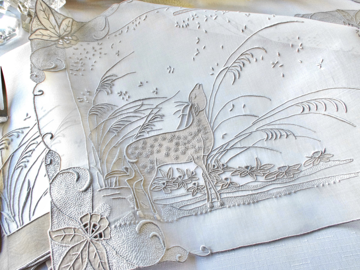 Detail of vintage Marghab “Deer” placemat showing embroidered grasses and landscape in gray organdy.