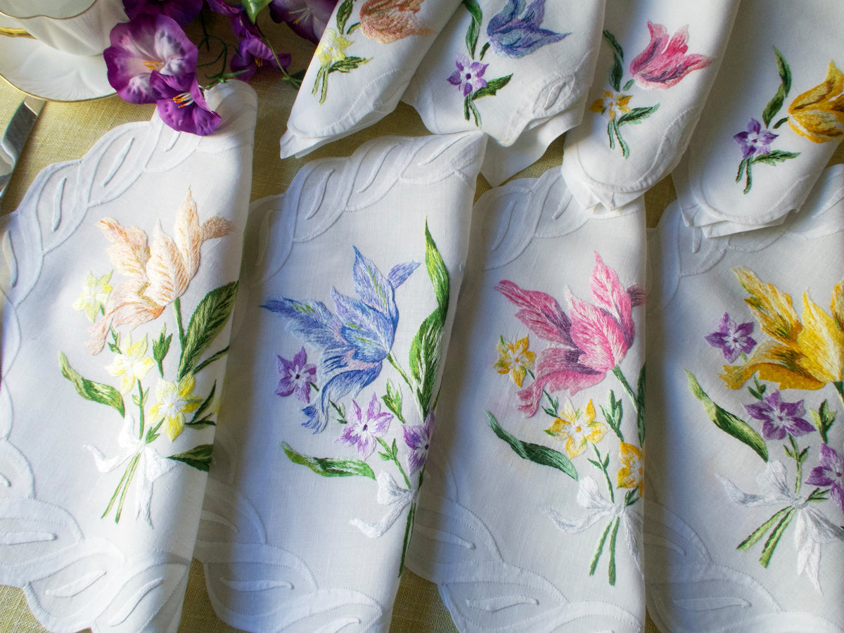 Vintage French linen placemats with hand embroidered flowers and scalloped edges.