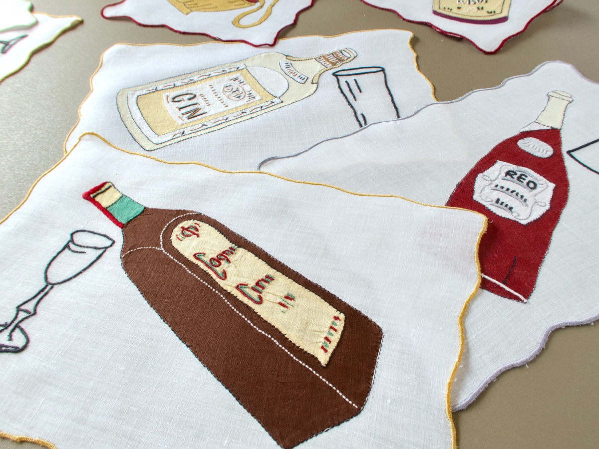 Vintage Madeira cocktail napkins with appliqué gin, red wine and cognac bottles and embroidered glasses on linen