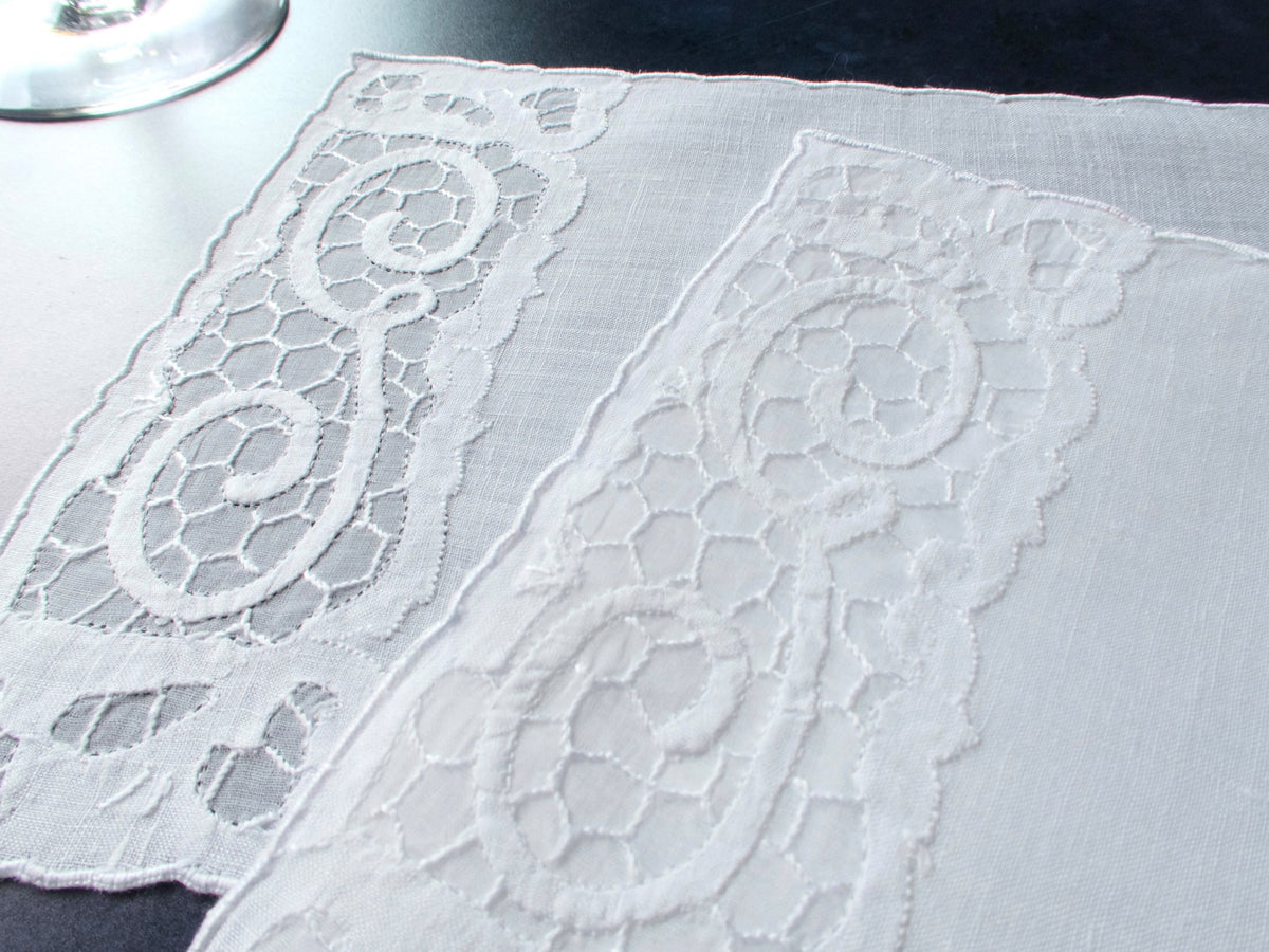 Two vintage Madeira linen cocktail napkins with a G monogram in a honeycomb organdy window