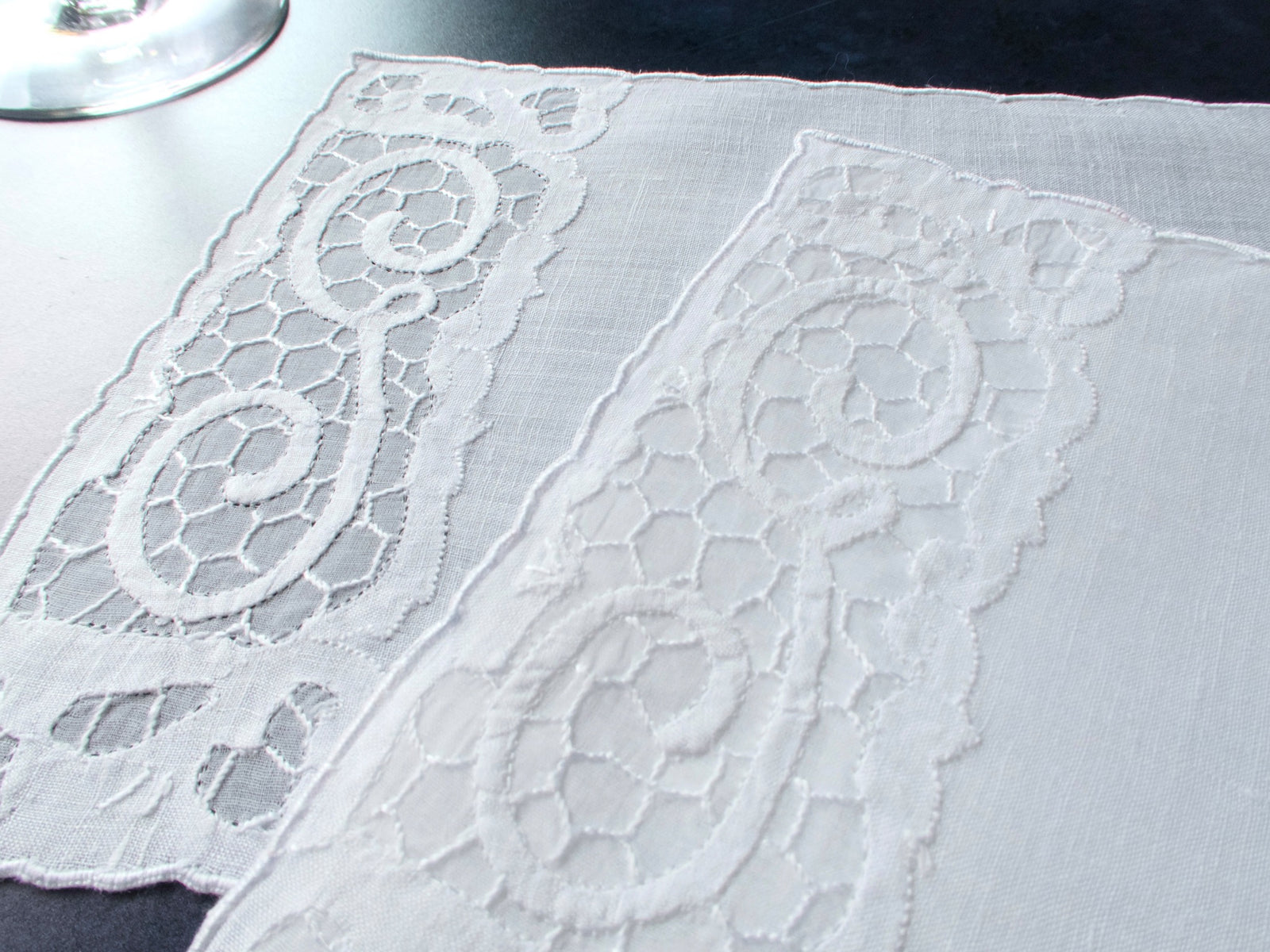 Two vintage Madeira linen cocktail napkins with a G monogram in a honeycomb organdy window