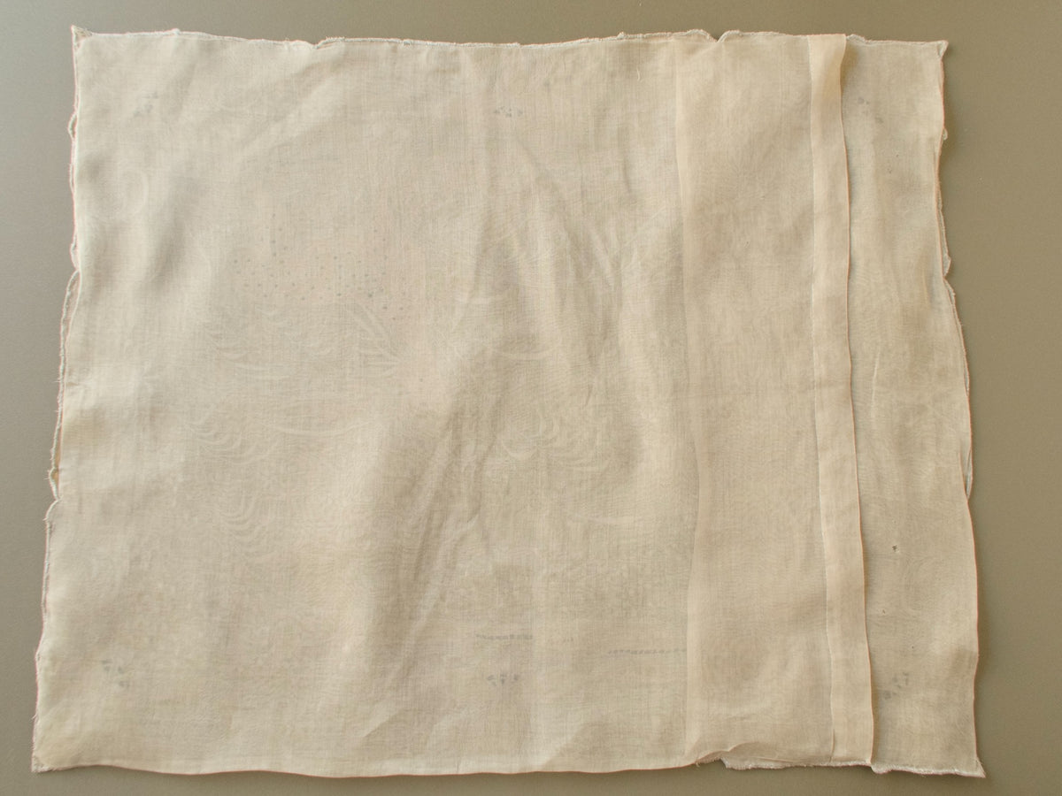 Back of a vintage Marghab "Deer" organdy pillow cover showing the sheer organdy and overlapping back opening