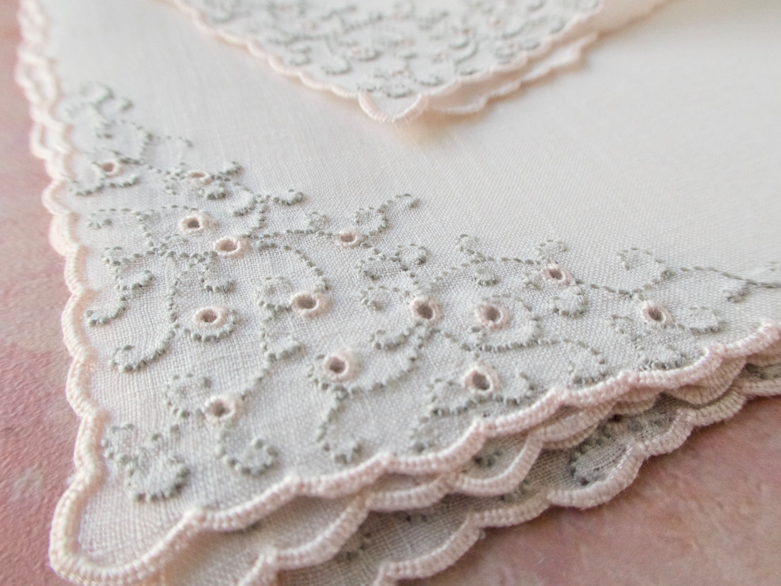 Vintage Marghab “Thousand Eye” cocktail napkins in pale pink, hand embroidered in Madeira on Irish linen with intricate eyelet embroidery and scalloped edges.
