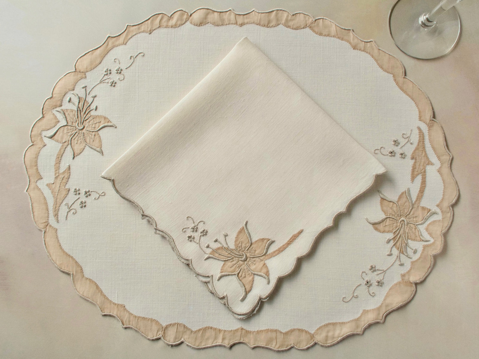 Vintage Madeira oval placemat with folded napkin, ecru linen with dimensional lily in organdy appliqué and elaborately scalloped border with organdy appliqué