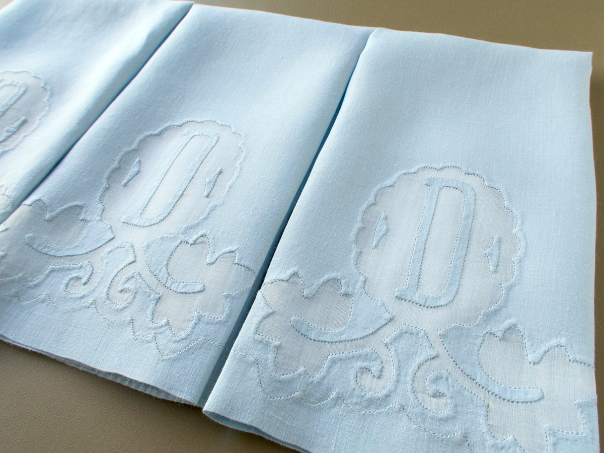 Close view of the appliquéd D monogram and leaf scrolls on a vintage Madeira linen guest towel