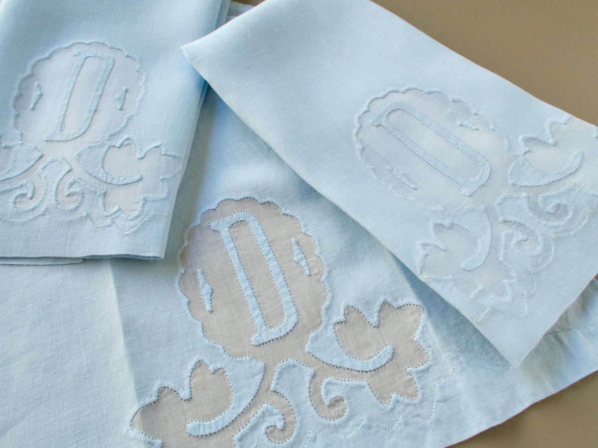 Three vintage Madeira linen guest towels with a D monogram appliquéd on an organdy window and scrolling leaves