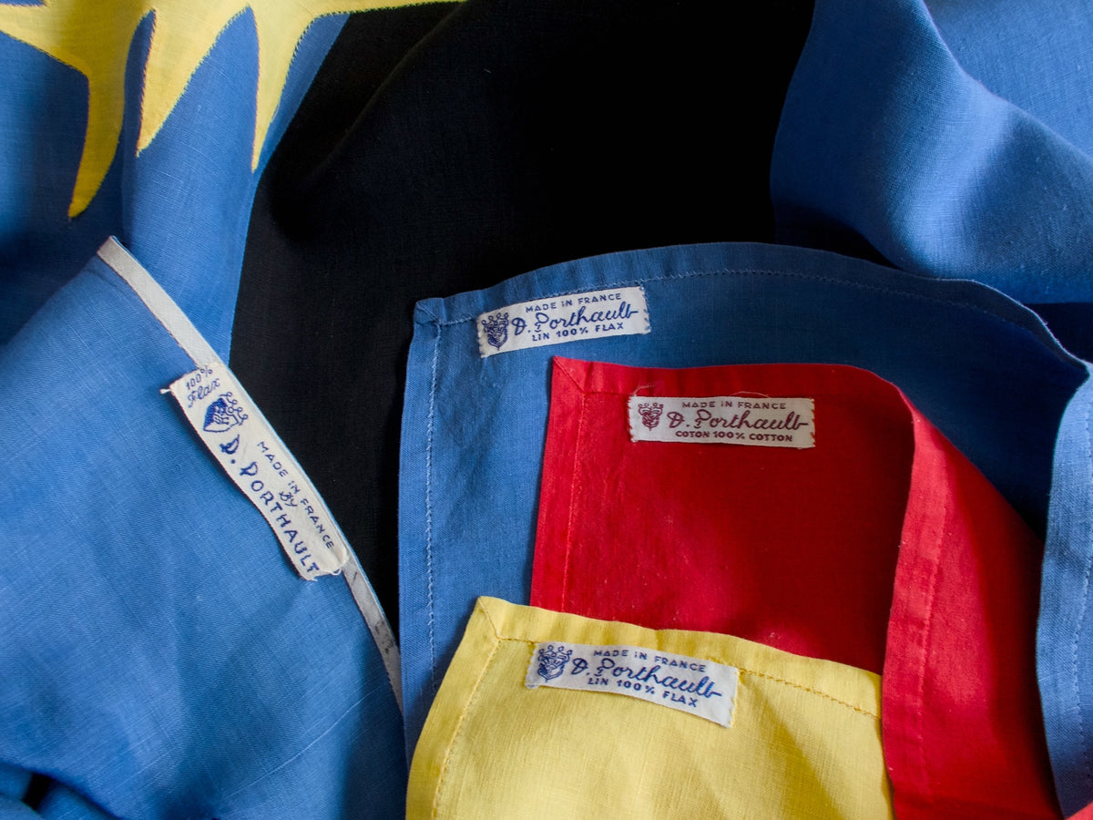 Close-up of vintage Porthault Paris labels on the ‘Cirque’ tablecloth and napkins.