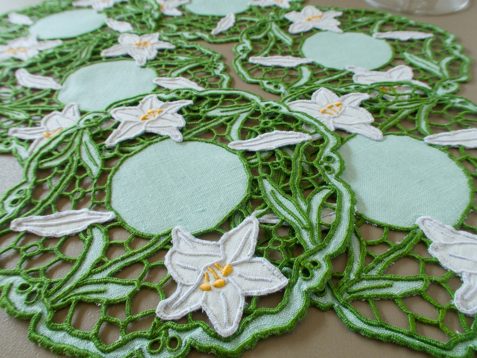 Vintage Madeira cocktail napkins with green Richelieu embroidery, pale green linen centers and dimensional white lilies.