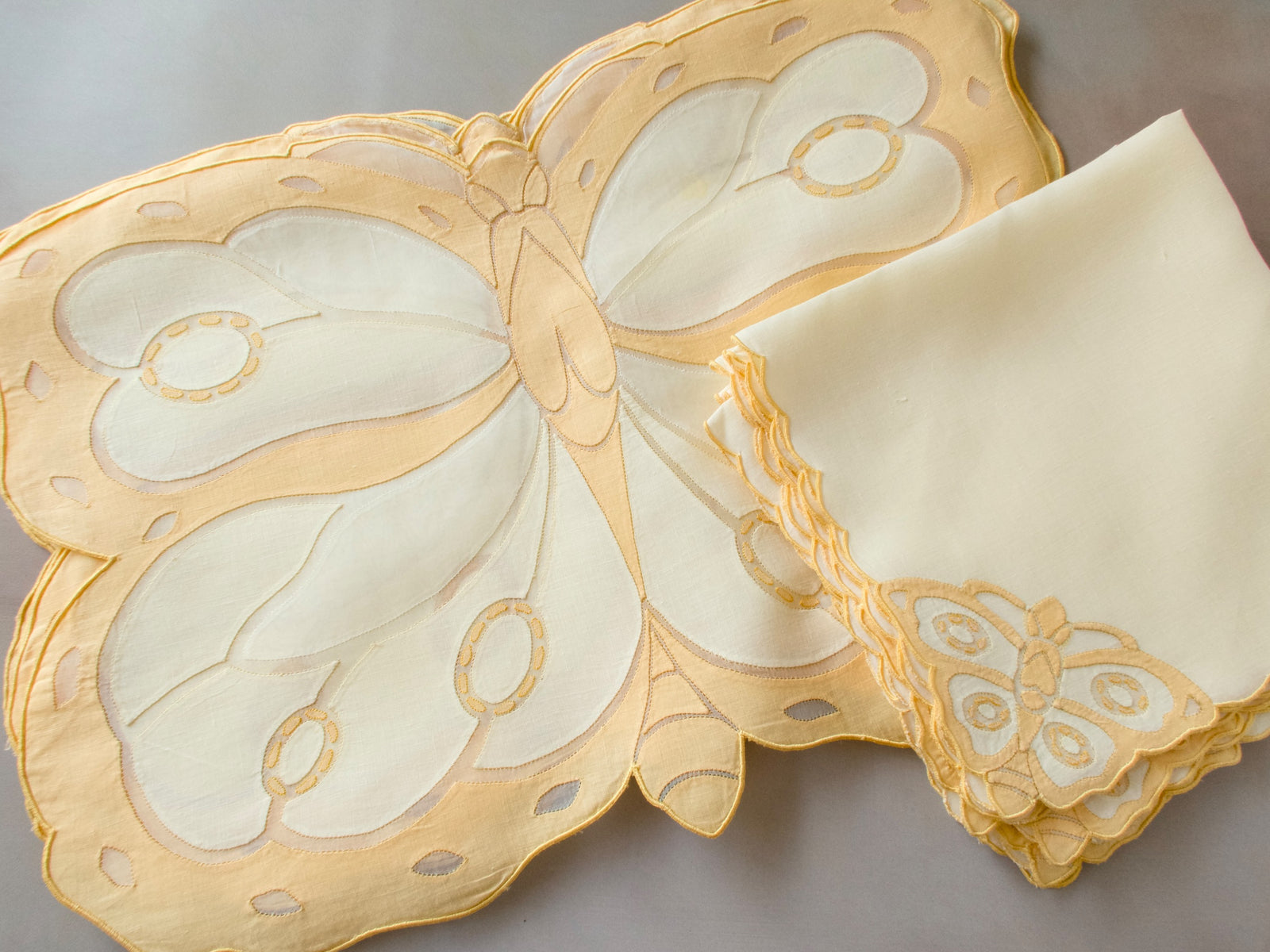 Vintage Madeira butterfly-shaped placemat and napkin set, showing sculptural organdy and linen wings with appliqué detail, set for 8