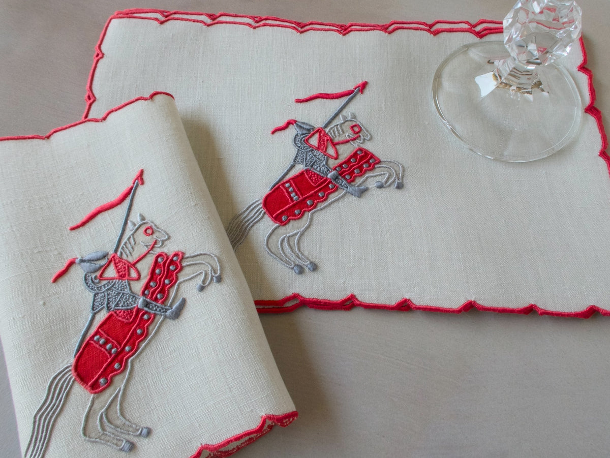 Vintage Marghab Knight pattern cocktail napkins, red embroidery on oyster-colored linen showing knight on horseback, handmade in Madeira.
