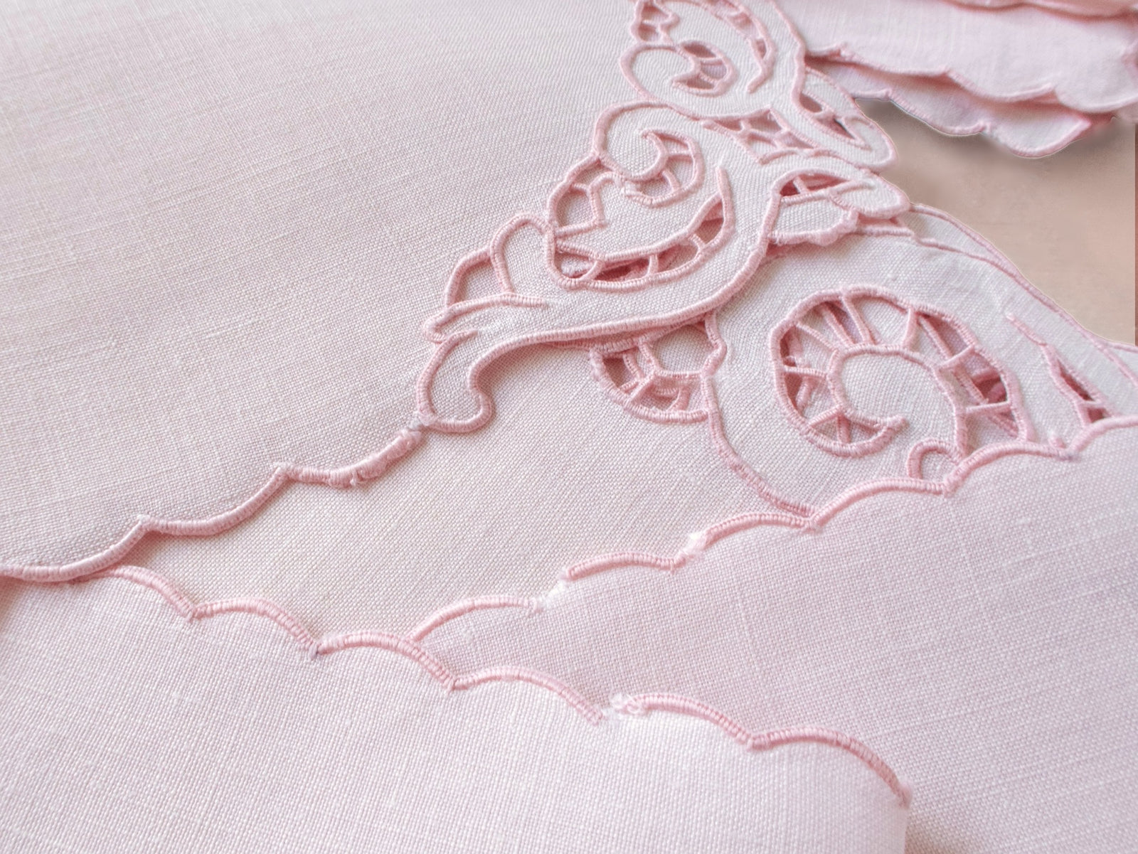 Detail of vintage Madeira pink Irish linen showing Richelieu cutwork scrollwork border and condition disclosure​​​​​​​​​​​​​​​​