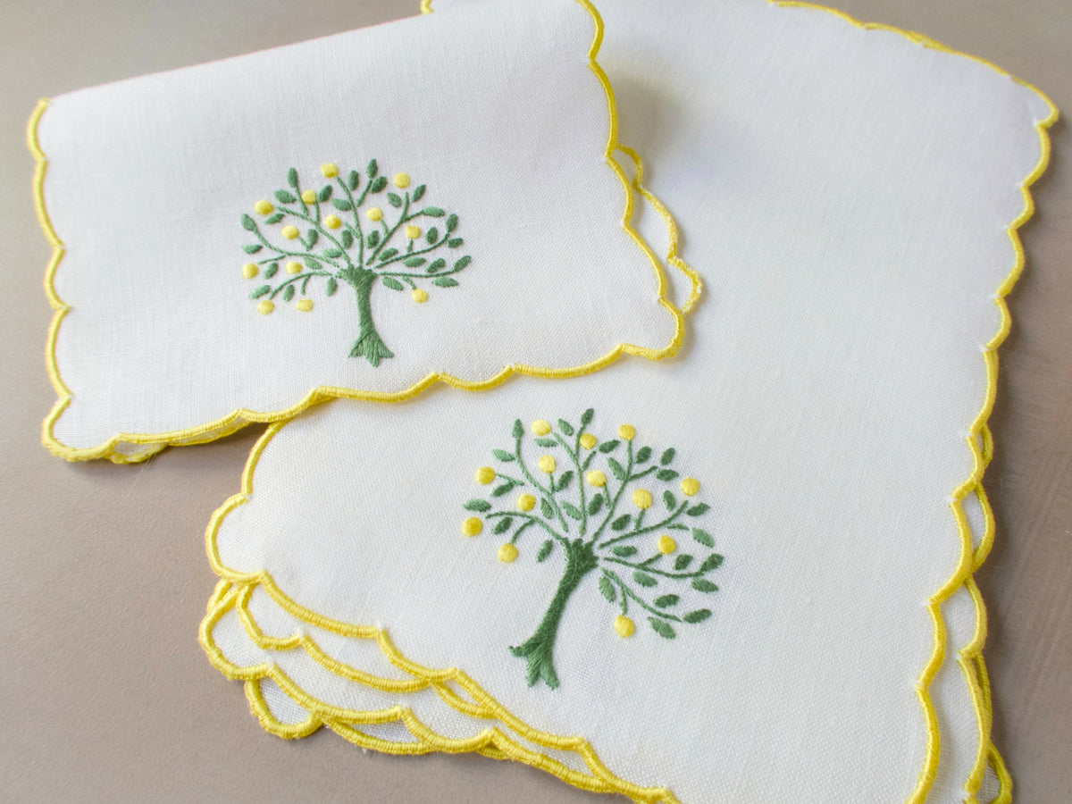 Set of six vintage Madeira cocktail napkins hand embroidered with lemon tree motif in green and yellow on white linen with yellow scalloped edging​​​​​​​​​​​​​​​​