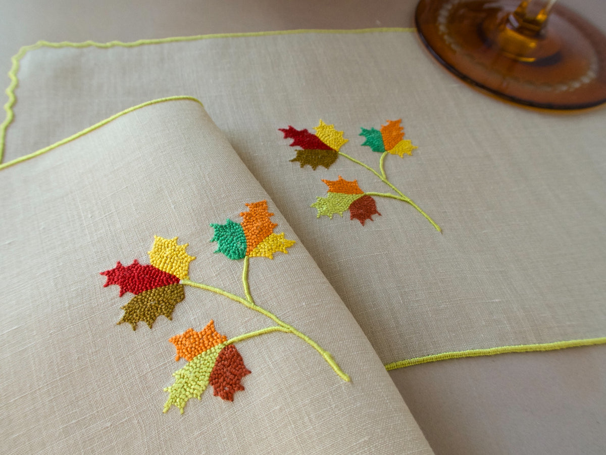 Marghab Maple Leaf cocktail napkins, hand embroidered in warm autumn tones on fine linen.