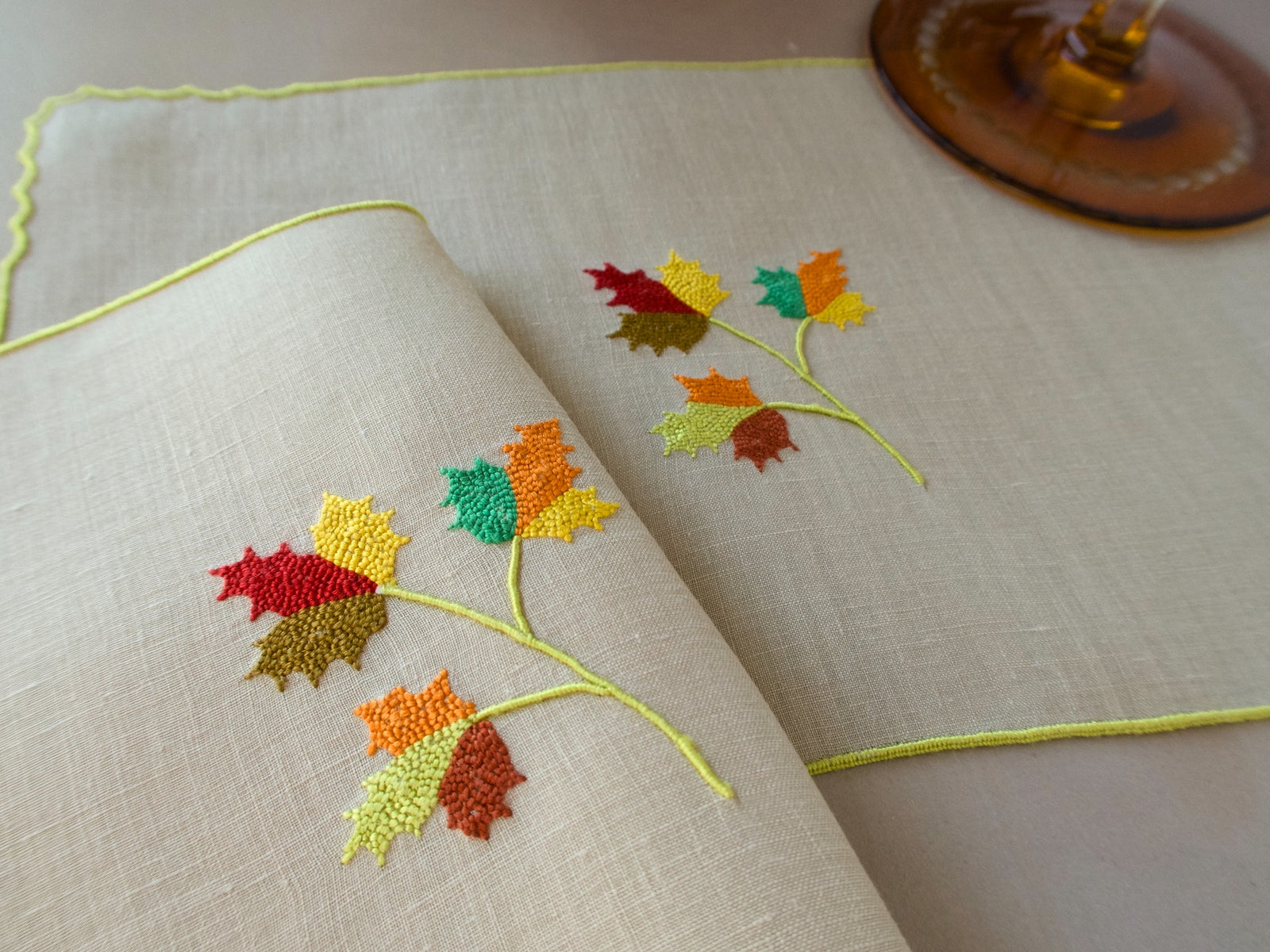 Marghab Maple Leaf cocktail napkins, hand embroidered in warm autumn tones on fine linen.
